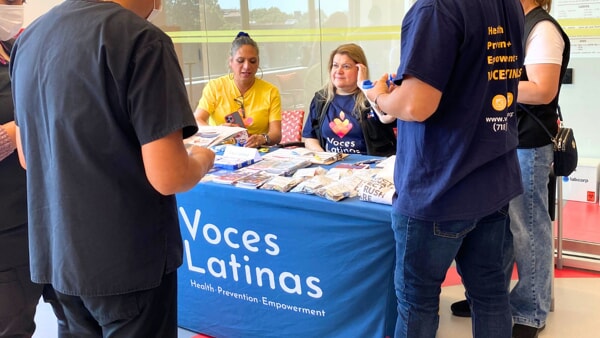 Representatives from Voces Latinas draw a crowd around their table during Apicha’s annual National Health Center Week Health Fair
